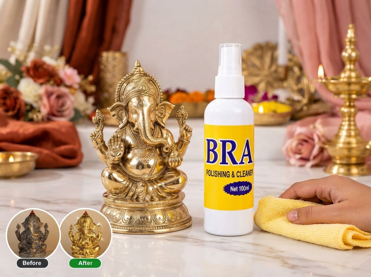 A bottle of brass polishing spray next to a sparkling, polished brass lamp on a marble surface with festive decor.